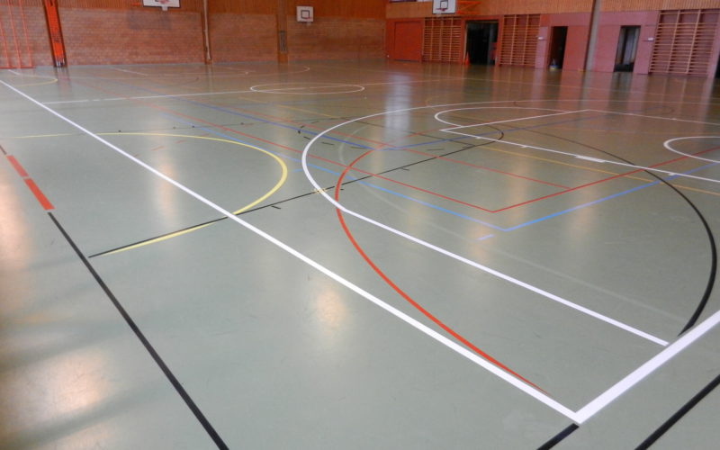 Nouveau marquage de basket en blanc dans une salle de sport au sol vert