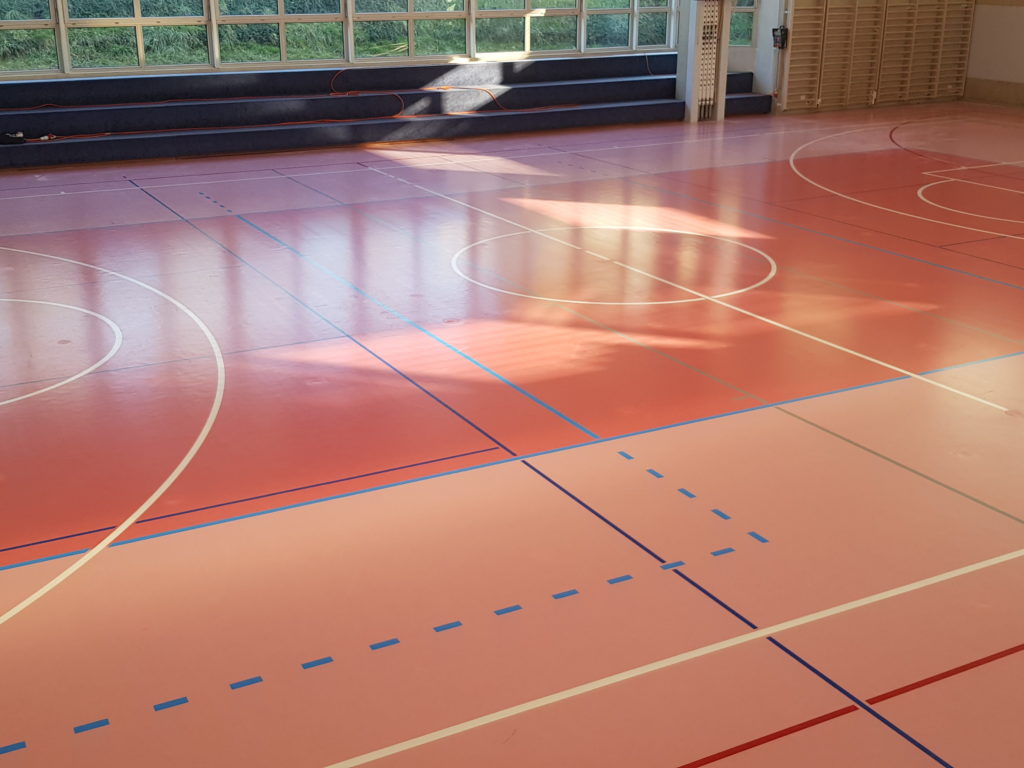 Salle de sport repeinte après assèchement, lignes de jeu reprises sur l'ensemble de la surface