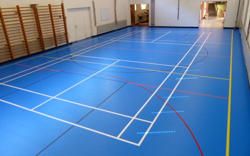 Salle communale avec un nouveau sol sportif en résine bleu ciel et un marquage multisport