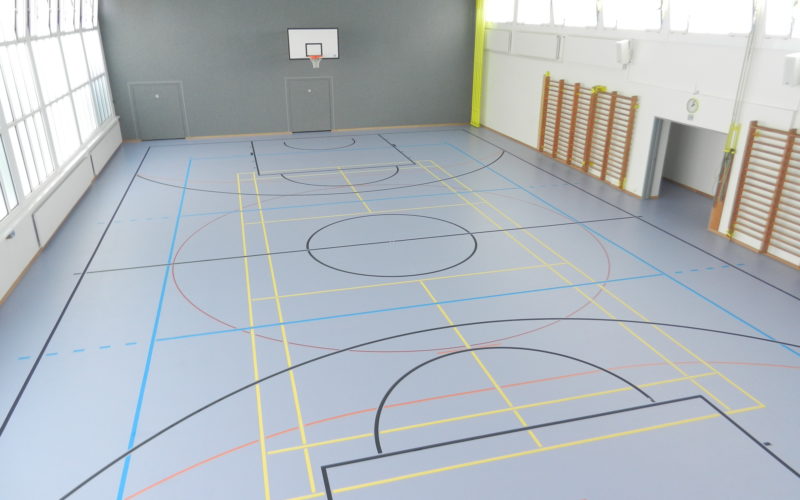 Salle de gymnastique scolaire avec un nouveau sol sportif sans joint en résine polyuréthane