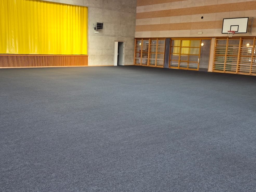 Salle polyvalente dont tout le sol sportif est recouvert d'une protection, prête pour une manifestation